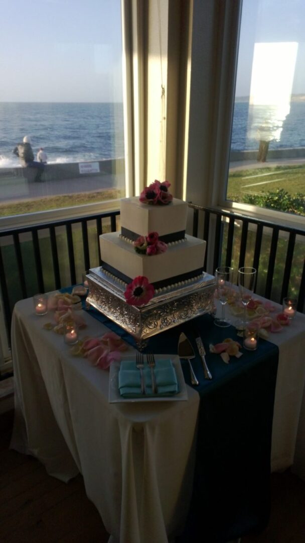 Elegant cake setup near seaside window