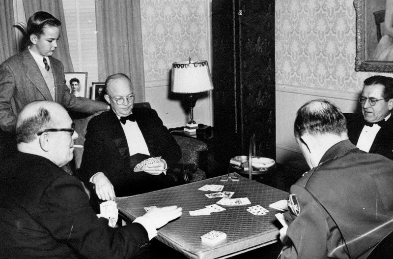 Group of men engaged in poker game