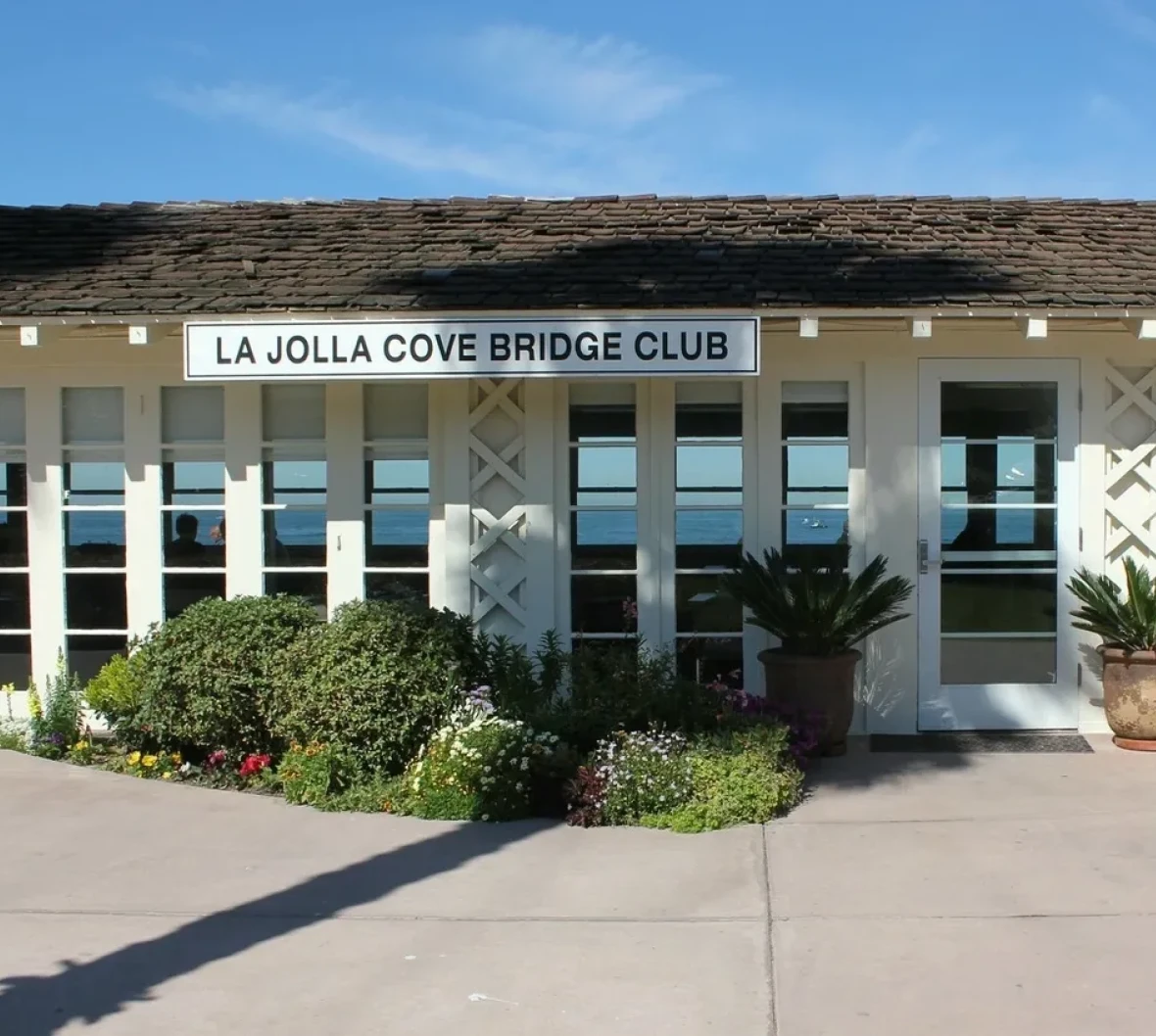 White building with garden path