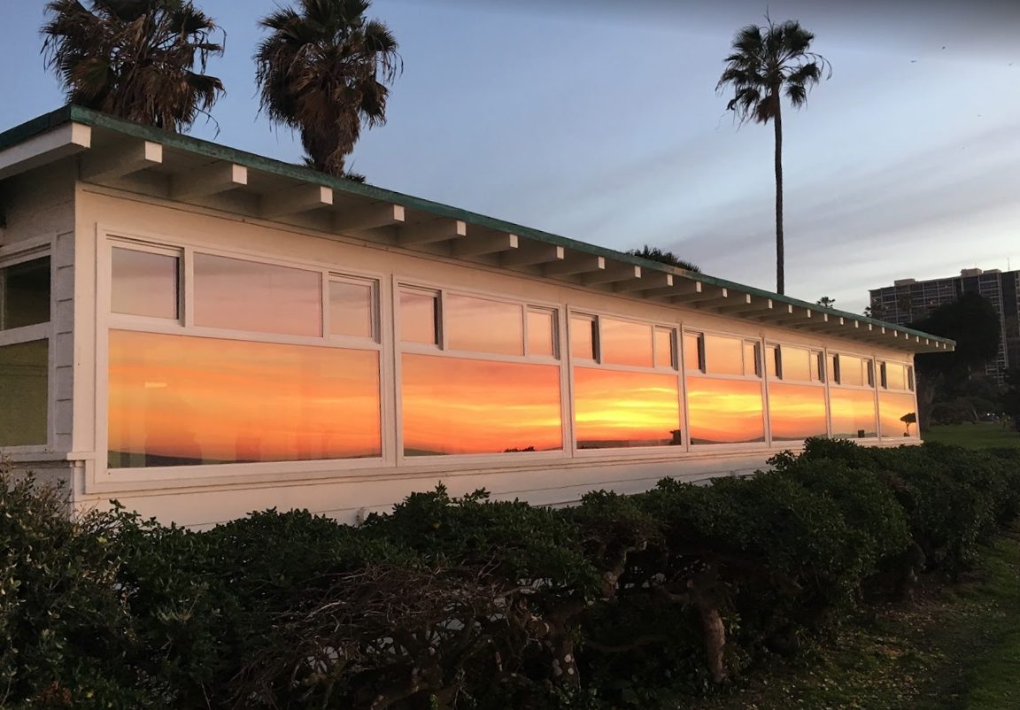 Palm trees and sunset mirrored in windows