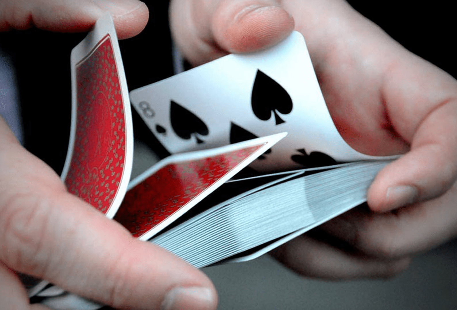 Hands expertly shuffling cards
