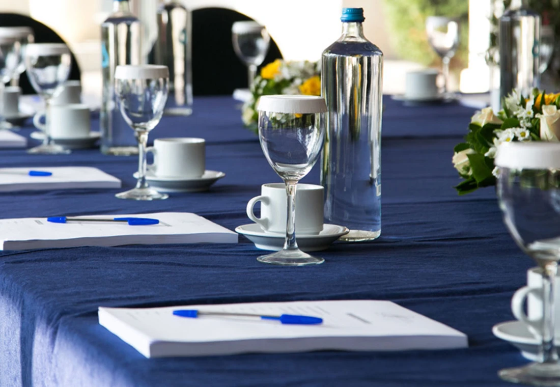Elegant meeting table with glasses and flowers